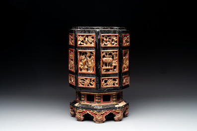 A Chinese octagonal gilt-lacquered wooden stand and four wooden carvings on stands, 19th C.