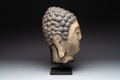 A large Chinese stone head of Buddha with traces of gilding and polychromy, Ming