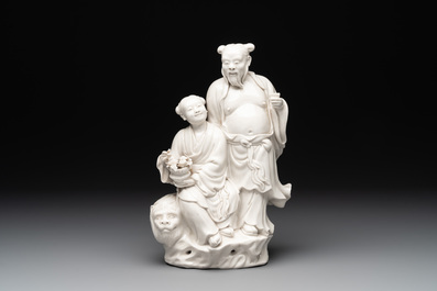 A Chinese Dehua blanc de Chine group of a man and a seated boy on a lion, 20th C.