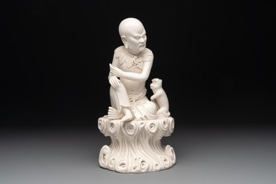 A Chinese Dehua blanc de Chine group of a seated Luohan with a monkey, 20th C.