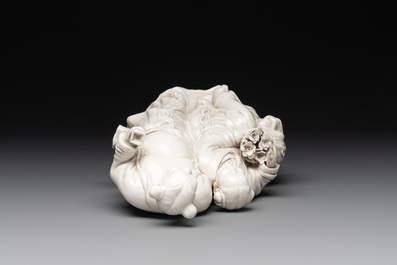 A Chinese Dehua blanc de Chine group of a man and a seated boy on a lion, 20th C.