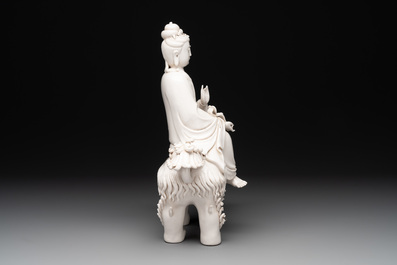 A Chinese Dehua blanc de Chine Guanyin with a ruyi sceptre seated on a Buddhist lion, 20th C.