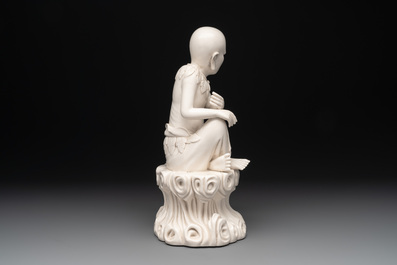A Chinese Dehua blanc de Chine group of a seated Luohan with a monkey, 20th C.