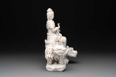 A Chinese Dehua blanc de Chine Bodhisattva seated on a Buddhist lion, 20th C.