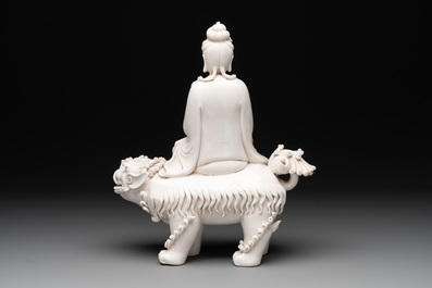 A Chinese Dehua blanc de Chine Guanyin with a ruyi sceptre seated on a Buddhist lion, 20th C.