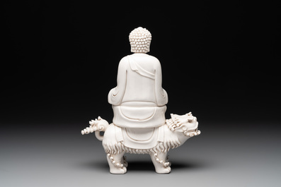 A Chinese Dehua blanc de Chine Buddha seated on a lion, 20th C.