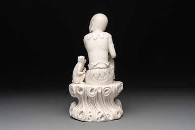 A Chinese Dehua blanc de Chine group of a seated Luohan with a monkey, 20th C.
