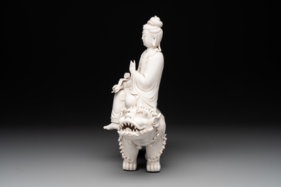 A Chinese Dehua blanc de Chine Guanyin with a ruyi sceptre seated on a Buddhist lion, 20th C.