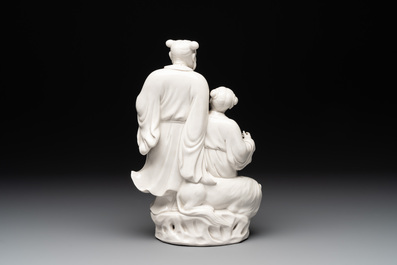 A Chinese Dehua blanc de Chine group of a man and a seated boy on a lion, 20th C.
