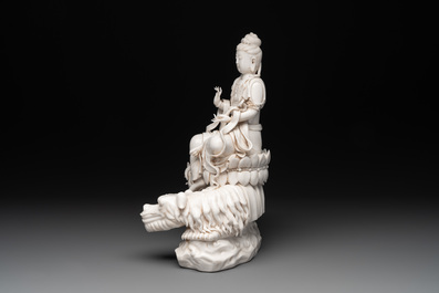 A Chinese Dehua blanc de Chine Bodhisattva seated on a Buddhist lion, 20th C.