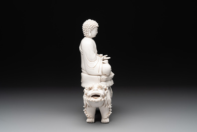 A Chinese Dehua blanc de Chine Buddha seated on a lion, 20th C.