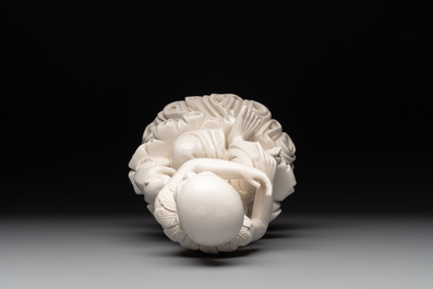 A Chinese Dehua blanc de Chine group of a seated Luohan with a monkey, 20th C.