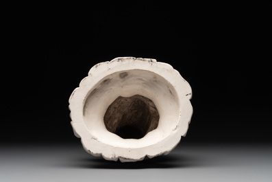 A Chinese Dehua blanc de Chine group of a seated Luohan with a monkey, 20th C.