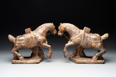 A pair of Chinese archaistic carved stone horses, 20th C.