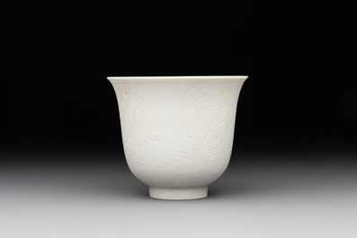 A Chinese white-glazed biscuit 'dragon' cup, Kangxi mark, 19th C.