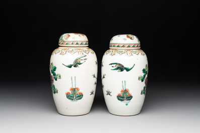 A pair of Chinese famille verte 'pheasant among flowering branches' vases and covers, 19th C.