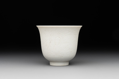 A Chinese white-glazed biscuit 'dragon' cup, Kangxi mark, 19th C.