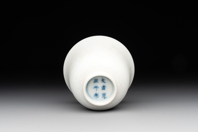 A Chinese white-glazed biscuit 'dragon' cup, Kangxi mark, 19th C.