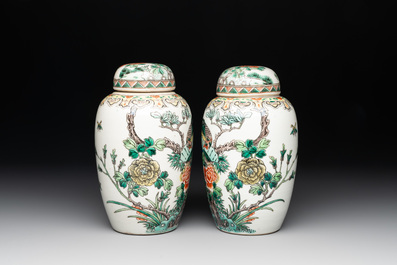 A pair of Chinese famille verte 'pheasant among flowering branches' vases and covers, 19th C.