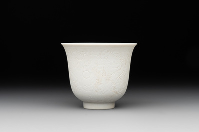 A Chinese white-glazed biscuit 'dragon' cup, Kangxi mark, 19th C.