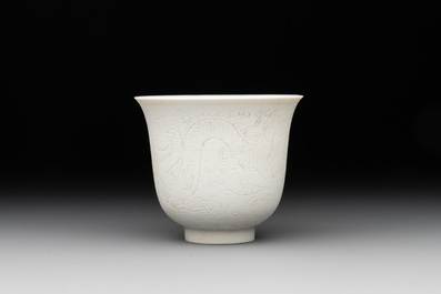 A Chinese white-glazed biscuit 'dragon' cup, Kangxi mark, 19th C.