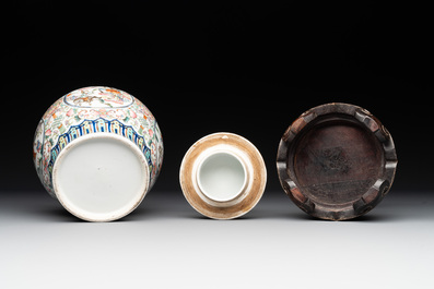 A pair of Chinese famille rose covered vases with figural design and wooden stands, 19th C.