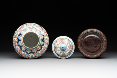 A pair of Chinese famille rose covered vases with figural design and wooden stands, 19th C.