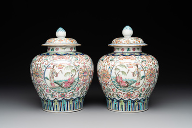 A pair of Chinese famille rose covered vases with figural design and wooden stands, 19th C.
