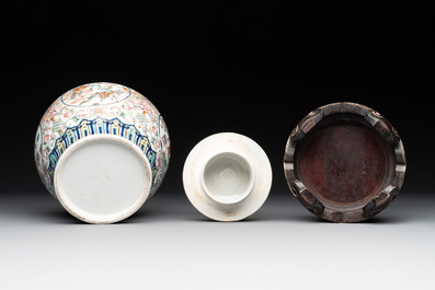 A pair of Chinese famille rose covered vases with figural design and wooden stands, 19th C.