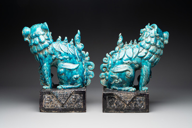 A pair of Chinese turquoise-and-aubergine-glazed Buddhist lions on stands, probably Swatow kilns, 19th C.