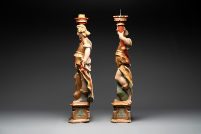 A pair of gilt and polychromed wooden angel-form candlesticks, Germany, 18/19th C.