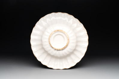 A Dutch Delft or Haarlem blue, white and yellow gadrooned dish with a putto, 17th C.