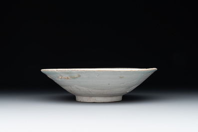 Four Chinese white-glazed saucers and three bowls, Yuan/Ming