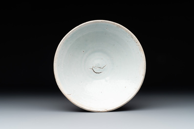 Four Chinese white-glazed saucers and three bowls, Yuan/Ming