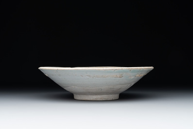 Four Chinese white-glazed saucers and three bowls, Yuan/Ming