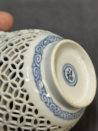 A Chinese blue and white reticulated double-walled cup and saucer, fu mark, Kangxi