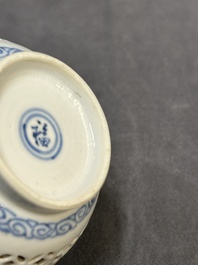 A Chinese blue and white reticulated double-walled cup and saucer, fu mark, Kangxi