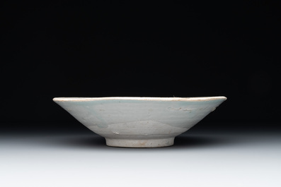 Four Chinese white-glazed saucers and three bowls, Yuan/Ming