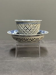 A Chinese blue and white reticulated double-walled cup and saucer, fu mark, Kangxi