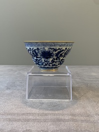 A Chinese gilt-decorated blue and white 'lotus scroll' bowl, Daoguang mark and of the period