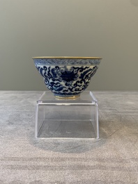 A Chinese gilt-decorated blue and white 'lotus scroll' bowl, Daoguang mark and of the period