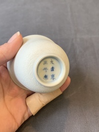 A Chinese white-glazed biscuit 'dragon' cup, Kangxi mark, 19th C.