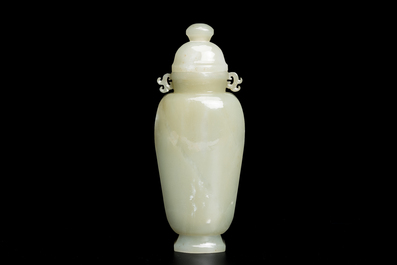 A Chinese white and russet jade lotus-form brush washer and two covered vases, Qing