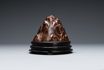 A Chinese agarwood carving of a mountain on wooden stand, 18/19th C.