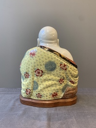 A large Chinese famille rose Milefo Buddha on wooden stand, 20th C.