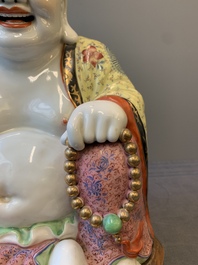 A large Chinese famille rose Milefo Buddha on wooden stand, 20th C.
