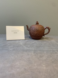 A Chinese Yixing stoneware teapot with boys among flower scrolls, Kangxi