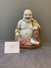 A large Chinese famille rose Milefo Buddha on wooden stand, 20th C.