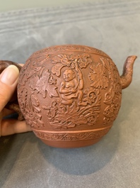 A Chinese Yixing stoneware teapot with boys among flower scrolls, Kangxi