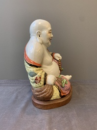 A large Chinese famille rose Milefo Buddha on wooden stand, 20th C.